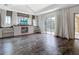 Bright living room features tile flooring, media center with fireplace and large windows with natural light at 1443 Obear Ct, Wesley Chapel, FL 33543