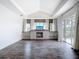 Bright living room features tile flooring, media center with fireplace and large windows with natural light at 1443 Obear Ct, Wesley Chapel, FL 33543