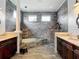 Luxurious main bathroom features a soaking tub with tiled surround, dual vanities, and a walk-in shower at 1443 Obear Ct, Wesley Chapel, FL 33543