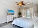 Comfortable bedroom featuring elegant furniture, ceiling fan, and sliding glass doors that provides pool views at 1443 Obear Ct, Wesley Chapel, FL 33543