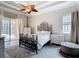 Spacious main bedroom boasts a decorative ceiling fan, stylish furniture, and sliding glass doors to the outdoor living area at 1443 Obear Ct, Wesley Chapel, FL 33543