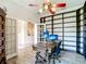 Bright office features a large shelving unit, vintage desk, and plenty of natural light at 1443 Obear Ct, Wesley Chapel, FL 33543