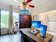 Well-lit home office with large desk and storage at 1443 Obear Ct, Wesley Chapel, FL 33543