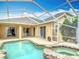 A screened-in pool and spa offer a relaxing oasis next to the home at 1443 Obear Ct, Wesley Chapel, FL 33543