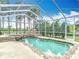 Beautiful screened pool area features a stone waterfall and private backyard at 1443 Obear Ct, Wesley Chapel, FL 33543