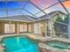 A screened-in pool and spa offer a relaxing oasis with views of the home at 1443 Obear Ct, Wesley Chapel, FL 33543