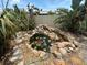 Backyard pond with rock features, lush greenery, and water lilies, creating a serene outdoor escape at 1559 San Roy Dr, Dunedin, FL 34698