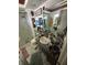 Bathroom showcasing a sink, toilet, and shower with an array of toiletries at 1559 San Roy Dr, Dunedin, FL 34698