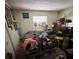 Interior bedroom featuring a bed, window, dresser, and a messy arrangement of items at 1559 San Roy Dr, Dunedin, FL 34698