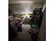 Messy bedroom with unmade bed, nightstand, and various belongings scattered around at 1559 San Roy Dr, Dunedin, FL 34698