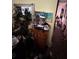 Wooden dresser covered in decor in a hallway with pictures hanging on the wall at 1559 San Roy Dr, Dunedin, FL 34698