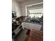 Kitchen with white cabinets, tile floor, and a corner sink under a window at 1559 San Roy Dr, Dunedin, FL 34698