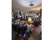 Cluttered living room with a TV mounted on the wall, a large lamp, and decor on the wall at 1559 San Roy Dr, Dunedin, FL 34698
