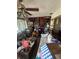 Interior of a cluttered living room with a pinball machine, a ceiling fan, and a red accent wall at 1559 San Roy Dr, Dunedin, FL 34698