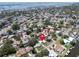 An aerial view of a waterfront property showing a dense neighborhood full of lush landscaping and mature trees at 1598 Brookside Blvd, Largo, FL 33770