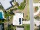 Aerial shot of a one-story home with a tile roof, solar panels, and an in-ground pool in the backyard at 1598 Brookside Blvd, Largo, FL 33770