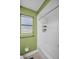 Bathroom featuring a tiled shower with a window and metal organizer at 1598 Brookside Blvd, Largo, FL 33770