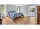 Bedroom featuring wood-look flooring, natural light and access to the lanai at 1598 Brookside Blvd, Largo, FL 33770