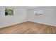 Bedroom with wood floor and two windows providing natural light, offering a comfortable living space at 1598 Brookside Blvd, Largo, FL 33770