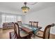Elegant dining room with wood floor, decorative light fixture, and windows providing ample natural light at 1598 Brookside Blvd, Largo, FL 33770