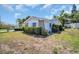Corner lot featuring a single-story home with well-manicured shrubbery and vinyl siding at 1598 Brookside Blvd, Largo, FL 33770