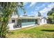 Well-maintained home featuring a screened lanai, lush lawn, and inviting backyard at 1598 Brookside Blvd, Largo, FL 33770
