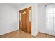 Close-up of the front door with decorative sidelights, complemented by brick wall and wood flooring at 1598 Brookside Blvd, Largo, FL 33770