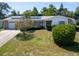 Charming single-story home with well-maintained landscaping, mature shade trees, and a two-car garage at 1598 Brookside Blvd, Largo, FL 33770