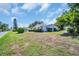 Well-manicured lawn and landscaping surround this single-story home in a quiet neighborhood at 1598 Brookside Blvd, Largo, FL 33770