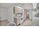 Kitchen featuring white appliances and neutral-colored cabinets with tile flooring at 1598 Brookside Blvd, Largo, FL 33770