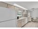Bright kitchen with white appliances, tile floors, and a window view at 1598 Brookside Blvd, Largo, FL 33770