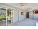 Enclosed patio with ceiling fans connects indoor/outdoor spaces with sliding door access at 1598 Brookside Blvd, Largo, FL 33770