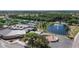 An aerial view of the community center, tennis courts and pond within a vibrant setting at 1643 Emerald Dunes Dr, Sun City Center, FL 33573
