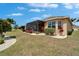Well-maintained backyard with screen lanai, lush landscaping, and plenty of space at 1643 Emerald Dunes Dr, Sun City Center, FL 33573