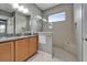 Bright bathroom with light cabinets, granite countertops, glass enclosed shower and tile flooring at 1643 Emerald Dunes Dr, Sun City Center, FL 33573