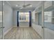 Bedroom featuring a ceiling fan, window with blinds, and custom built-in shelving at 1643 Emerald Dunes Dr, Sun City Center, FL 33573
