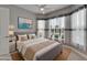 Serene bedroom features soft decor and large windows, creating a relaxing retreat at 1643 Emerald Dunes Dr, Sun City Center, FL 33573