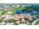 Aerial showing the community pool, golf course, clubhouse and lake views at 1643 Emerald Dunes Dr, Sun City Center, FL 33573