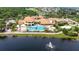 Beautiful aerial view shows community pool, clubhouse, and surrounding manicured landscaping at 1643 Emerald Dunes Dr, Sun City Center, FL 33573