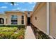 Charming entrance with a brick walkway, leading through lush landscaping and into the home at 1643 Emerald Dunes Dr, Sun City Center, FL 33573