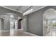 Hallway featuring arched doorways, decorative lighting, and tile floors leading to other rooms at 1643 Emerald Dunes Dr, Sun City Center, FL 33573