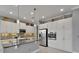 Modern kitchen with white cabinets, granite countertops, stainless steel appliances, and decorative backsplash at 1643 Emerald Dunes Dr, Sun City Center, FL 33573