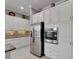 Kitchen featuring stainless steel appliances, custom cabinets, and granite countertops at 1643 Emerald Dunes Dr, Sun City Center, FL 33573