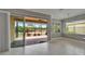 Bright living room with neutral walls, tile floors, and a screened patio, creating a comfortable indoor-outdoor flow at 1643 Emerald Dunes Dr, Sun City Center, FL 33573