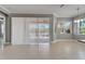 Bright and airy living room featuring tile floors, neutral walls, and sliding doors to a screened-in patio at 1643 Emerald Dunes Dr, Sun City Center, FL 33573