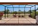 The spacious screened patio with brick floors provides a clear view of the landscaped backyard at 1643 Emerald Dunes Dr, Sun City Center, FL 33573