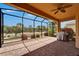 Spacious screened patio features brick floors, ceiling fan, and a grill, perfect for outdoor entertaining at 1643 Emerald Dunes Dr, Sun City Center, FL 33573