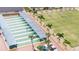 Aerial view of shuffleboard courts near a row of palm trees and seating at 1643 Emerald Dunes Dr, Sun City Center, FL 33573