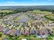 Wide aerial view of a Primary-planned community featuring homes, ponds, and verdant landscaping at 17610 Buckingham Garden Dr, Lithia, FL 33547