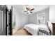 Cozy bedroom with neutral color scheme, ceiling fan, and a view to the outside at 17610 Buckingham Garden Dr, Lithia, FL 33547
